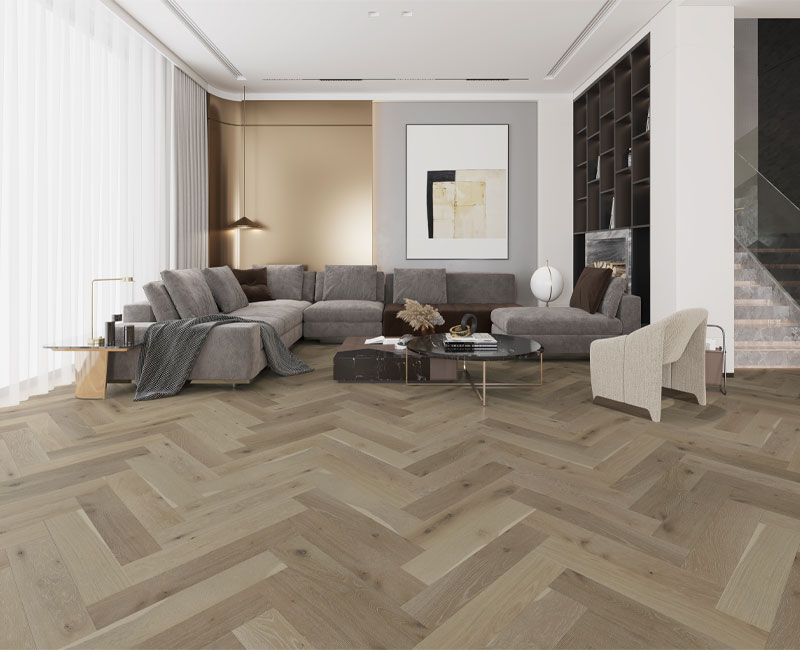 herringbone pattern hardwood flooring in living room with modern decor.
